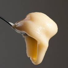 Cargar imagen en el visor de la galería, A spoonful of raw creamed honey, with a focus on the honey's smooth texture.